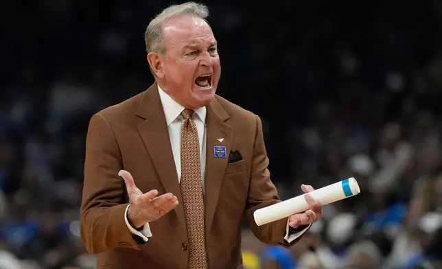 Texas head coach Vic Schaefer motions towards the court during the first half of a women's NCAA college basketball tournament semifinal game at the Final Four, Friday, April 3, 2026, in Phoenix. (AP Photo/Ross D. Franklin)