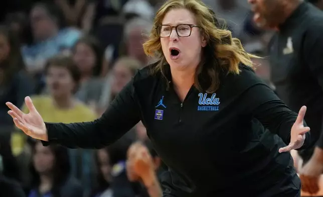 UCLA head coach Cori Close motions towards the court during the first half of a women's NCAA college basketball tournament semifinal game between UCLA and Texas at the Final Four, Friday, April 3, 2026, in Phoenix. (AP Photo/Ross D. Franklin)