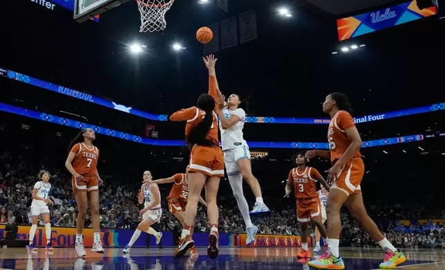 UCLA center Lauren Betts (51) shoots against Texas during the first half of a women's NCAA college basketball tournament semifinal game at the Final Four, Friday, April 3, 2026, in Phoenix. (AP Photo/Ross D. Franklin)
