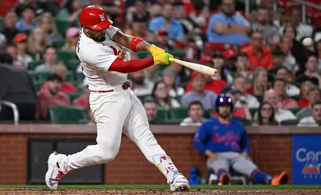 St. Louis Cardinals' Ivan Herrera hits a two run double in the third inning of a baseball game against the New York Mets, Tuesday, March 31, 2026, in St. Louis. (AP Photo/Joe Puetz)