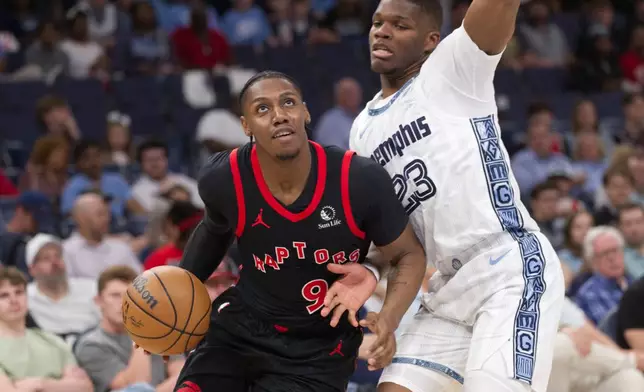 Toronto Raptors forward RJ Barrett (9) drives along the baseline while defended by Memphis Grizzlies forward Cedric Coward (23) during the first half of an NBA basketball game Friday, April 3, 2026, in Memphis, Tenn. (AP Photo/Nikki Boertman)
