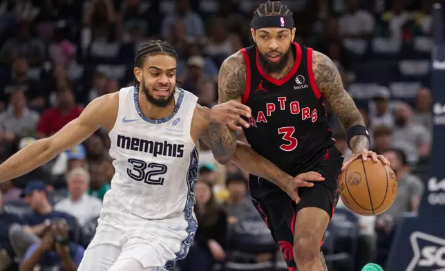 Memphis Grizzlies guard Rayan Rupert (32) defends against Toronto Raptors forward Brandon Ingram (3) during the first half of an NBA basketball game Friday, April 3, 2026, in Memphis, Tenn. (AP Photo/Nikki Boertman)