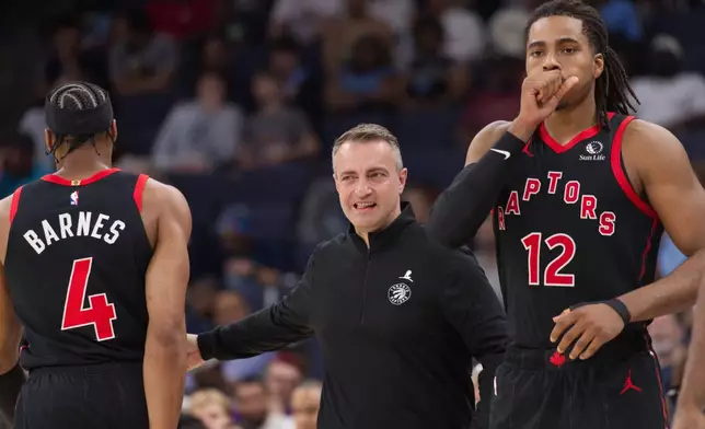 Toronto Raptors head coach Darko Rajakovic, center, reacts as he gives a rest to forward Scottie Barnes (4) as forward Collin Murray-Boyles (12) enters an NBA basketball game during the first half against the Memphis Grizzlies, Friday, April 3, 2026, in Memphis, Tenn. (AP Photo/Nikki Boertman)