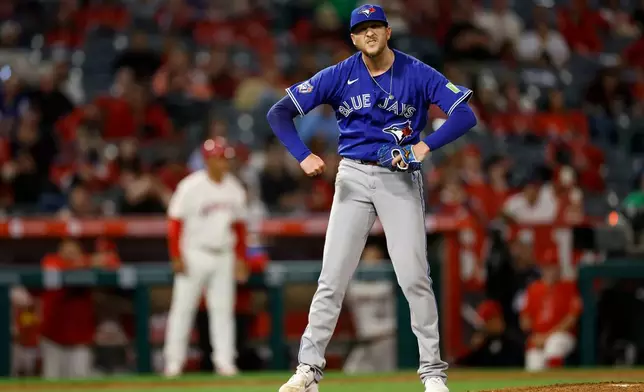 Toronto Blue Jays relief pitcher Jeff Hoffman (23) reacts after striking out the last Los Angeles Angels batter to win the game at the end of the ninth inning of a baseball game Monday, April 20, 2026, in Anaheim, Calif. (AP Photo/Caroline Brehman)