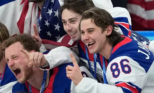 FILE - United States' Jack Hughes (86) poses with teammates after defeating Canada in the men's ice hockey gold medal game at the 2026 Winter Olympics, in Milan, Italy, Sunday, Feb. 22, 2026. (AP Photo/Petr David Josek, File)