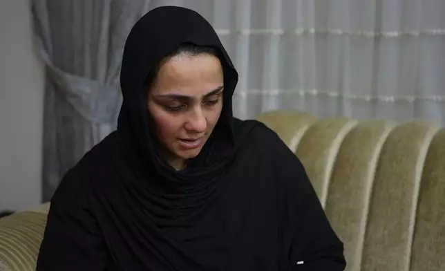 Sahar Sabti, niece of Iraqi singer Sajida Obaid, weeps during the seventh-day mourning gathering at the family home in Irbil, Iraq, Thursday, April 10, 2026. (AP Photo/Stella Martany)