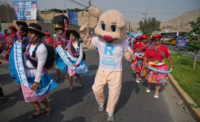 Supporters of presidential candidate Rafael López Aliaga, of the Popular Renewal party, dance as they arrive at a campaign rally in the Manchay neighborhood of Lima, Peru, Saturday, April 4, 2026. (AP Photo/Martin Mejia)