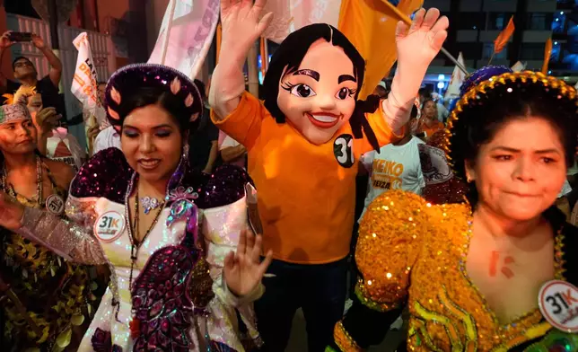 Supporters of presidential candidate Keiko Fujimori, of the Popular Force party, cheer outside of a debate ahead of the April 12 election in Lima, Peru, Tuesday, March 31, 2026. (AP Photo/Martin Mejia)
