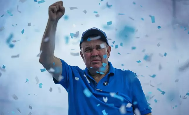Presidential candidate Rafael López Aliaga, of the Popular Renewal party, greets supporters upon arriving at a campaign rally in the Manchay neighborhood in Lima, Peru, Saturday, April 4, 2026. (AP Photo/Guadalupe Pardo)