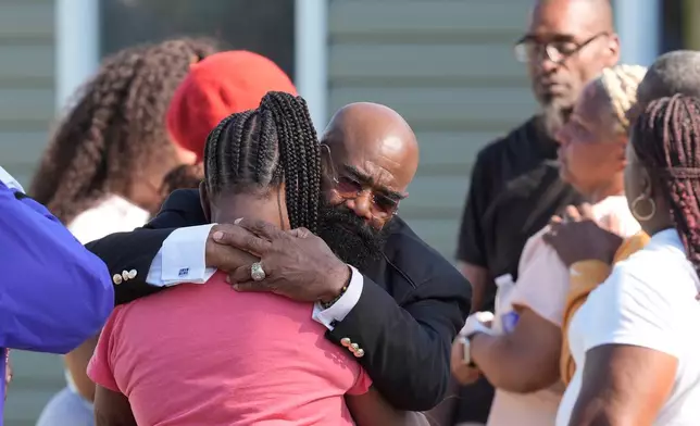 Councilman Reverend James Green consoles people outside the scene of a mass shooting, Sunday, April 19, 2026, in Shreveport, La. (AP Photo/Gerald Herbert)