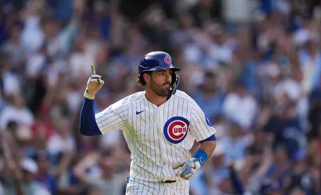 Chicago Cubs' Dansby Swanson reacts after driving in the game-winning run in the 10th inning of a baseball game against the Philadelphia Phillies, Thursday, April 23, 2026, in Chicago. (AP Photo/Erin Hooley)