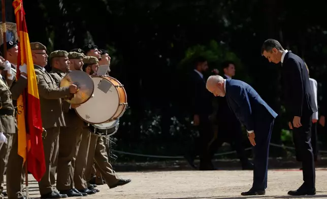 Spain's Prime Minister Pedro Sanchez, right, and Brazil's President Luiz Inacio Lula da Silva review troops during a Spain-Brazil summit in Barcelona, Spain, Friday, April 17, 2026. (AP Photo/Joan Monfort)