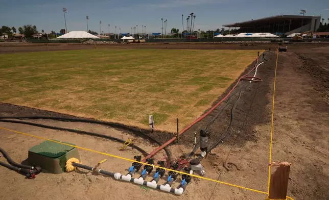 New fresh grass is grown for a world-class cricket pitch at the Pomona Fairplex on Wednesday, April 22, 2026, seen during the groundbreaking of the new Knight Riders Cricket Field, which will serve as the Los Angeles Knight Riders' official home field for 2026 and later host cricket at the LA 2028 Olympics. (AP Photo/Damian Dovarganes)