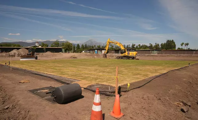 New fresh grass is grown for a world-class cricket pitch at the Pomona Fairplex on Wednesday, April 22, 2026, seen during the groundbreaking of the new Knight Riders Cricket Field, which will serve as the Los Angeles Knight Riders' official home field for 2026 and later host cricket at the LA 2028 Olympics. (AP Photo/Damian Dovarganes)