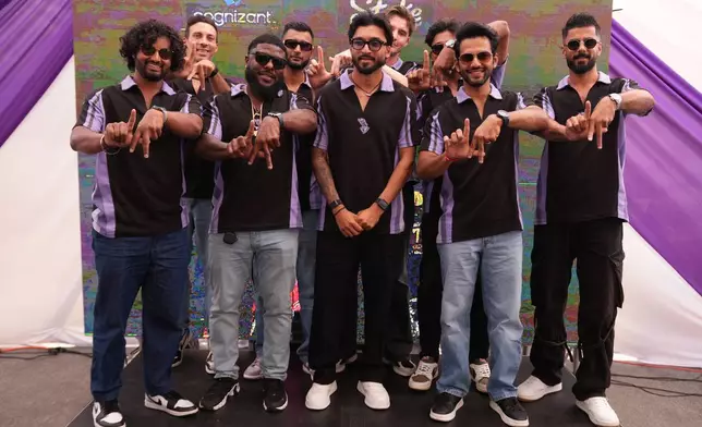 Members of the Los Angeles Knight Riders, cricket team form a LA sign with their hands as they pose for a picture at the Pomona Fairplex on Wednesday, April 22, 2026, during the groundbreaking ceremony of the new Knight Riders Cricket Field, which will serve as the Los Angeles Knight Riders' official home field for 2026 and later host cricket at the LA 2028 Olympics. (AP Photo/Damian Dovarganes)