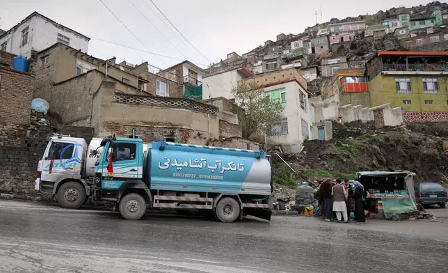 Residents collect water from a distribution truck in the Deh Mazang neighborhood in Kabul, Afghanistan, Thursday, April 2, 2026. (AP Photo/Siddiqullah Alizai)