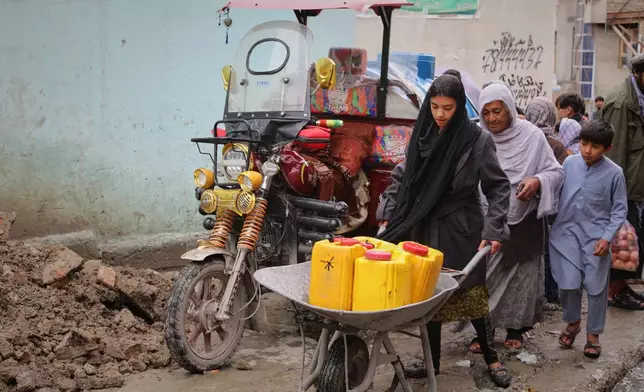A girl carries jerrycans on a wheelbarrow after collecting water from a well at a mosque in Deh Mazang, Kabul, Afghanistan, Thursday, April 2, 2026. (AP Photo/Siddiqullah Alizai)