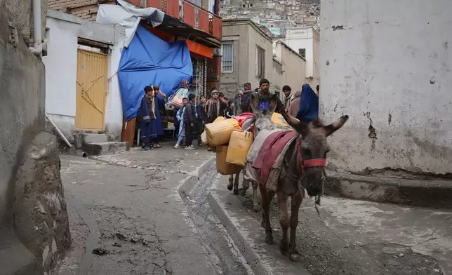 Residents carry jerrycans on donkeys after collecting water from a well at a mosque in Deh Mazang, Kabul, Afghanistan, Thursday, April 2, 2026. (AP Photo/Siddiqullah Alizai)