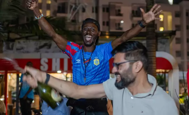 Congolese football fans celebrate in Goma, Democratic Republic of the Congo, as their team qualified for World Cup by winning over Jamaica in an intercontinental playoff, Wednesday, April 1, 2026.(AP Photo/Moses Sawasawa)