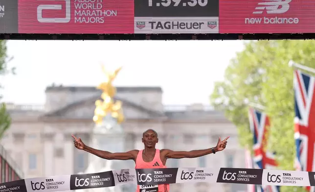 Sabastian Sawe from Kenya crosses the finish line to win the men's race at the London Marathon in London, Sunday, April 26, 2026.(AP Photo/Ian Walton)