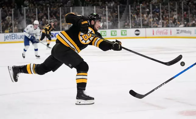 Boston Bruins left wing Tanner Jeannot shoots against the Tampa Bay Lightning during the first period of an NHL hockey game, Saturday, April 11, 2026, in Boston. (AP Photo/Robert F. Bukaty)