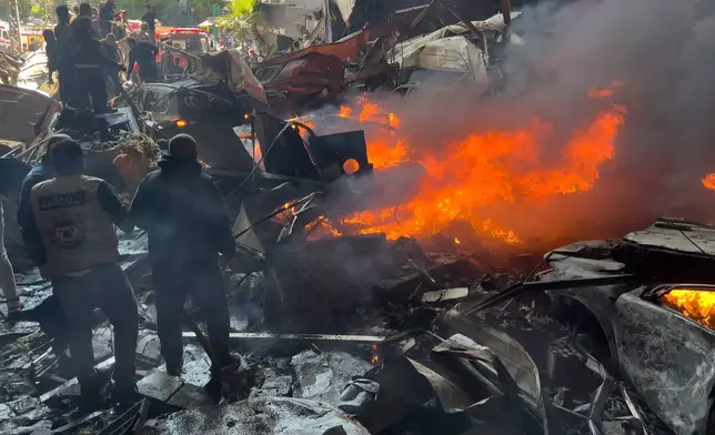 Rescuers gather at the site of an Israeli airstrike in central Beirut, Lebanon, Wednesday, April 8, 2026. (AP Photo/Hussein Malla)
