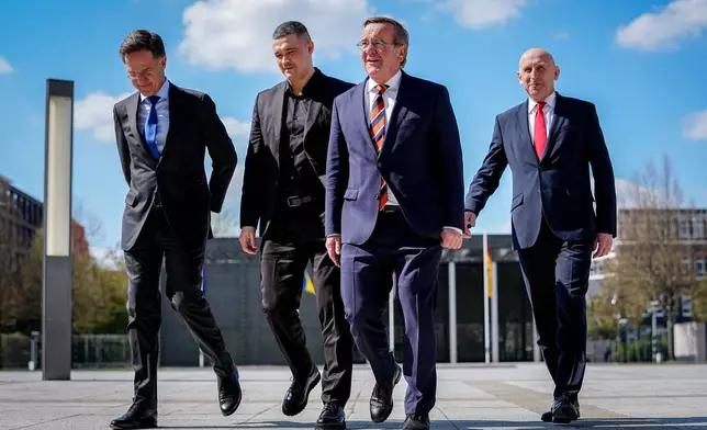 From left, Secretary General of NATO Mark Rutte, Ukraine's Minister of Defense Mykhailo Fedorov, Germany's Minister of Defense Boris Pistorius and Britain's Secretary of Defense John Healey gather for a photo at the Ukraine Contact Group meeting in front of the Federal Ministry of Defense in Berlin, Wednesday April 15, 2026. (Kay Nietfeld/dpa via AP)