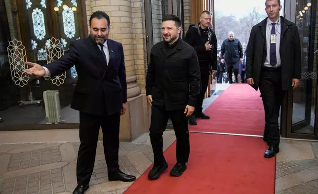Ukrainian President Volodymyr Zelenskyy is welcomed by the President of the Norwegian Parliament Masud Gharahkhani, left, during his visit to Norway on Wednesday April 15, 2026. (Stian Lysberg Solum/NTB via AP)