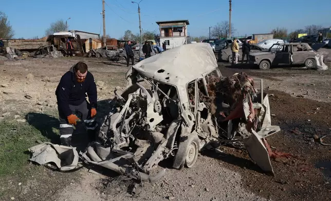 Cars damaged by Russia's drone attack are seen in Zaporizhzhia, Ukraine, Wednesday, April 15, 2026. (AP Photo/Kateryna Klochko)