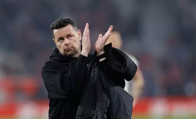 Lens' head coach Pierre Sage applauds to supporters at the end of the French League One soccer match between Lille and Lens, in Lille, France, Saturday, April 4, 2026. (AP Photo/Jean-Francois Badias)