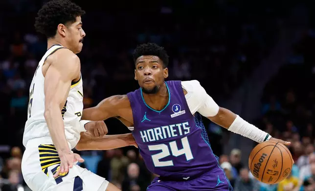 Charlotte Hornets forward Brandon Miller (24) drives to the basket against Indiana Pacers guard Ben Sheppard, left, during the first half of an NBA basketball game in Charlotte, N.C., Friday, April 3, 2026. (AP Photo/Nell Redmond)