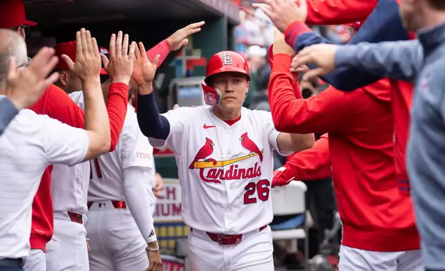 St. Louis Cardinals' JJ Wetherholt is congratulated by teammates after scoring during the sixth inning of a baseball game against the New York Mets Wednesday, April 1, 2026, in St. Louis. (AP Photo/LG Patterson)