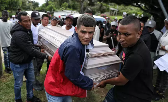 Relatives of a victim of an attack that killed at least 20 people on the Pan-American Highway, which authorities blamed on dissident former FARC rebels, carry a coffin for a wake in Cajibio, Colombia, Monday, April 27, 2026. (AP Photo/Santiago Saldarriaga)