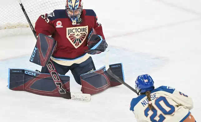 Vancouver Goldeneyes' Sarah Nurse (20) takes a shot on Montreal Victoire goaltender Ann-Renee Desbiens (35) during second period PWHL hockey game in Laval, Que., Wednesday, April 1, 2026. (Graham Hughes/The Canadian Press via AP)