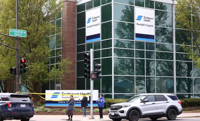 Police officers work the scene outside Endeavor Health Swedish Hospital in Lincoln Square, on Saturday, April 25, 2026. (Anthony Vazquez/Chicago Sun-Times via AP)