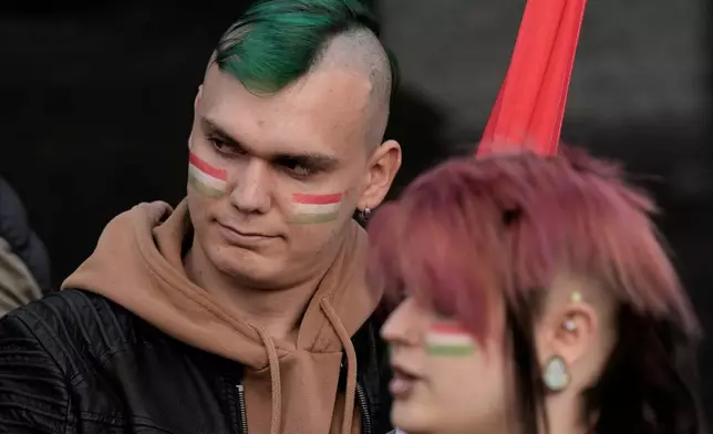 Supporters of Peter Magyar, the leader of the opposition Tisza party wait for the results of the parliamentary elections in Budapest, Hungary, Sunday, April 12, 2026. (AP Photo/Darko Bandic)