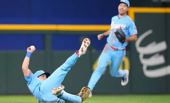 Texas Rangers outfielder Sam Haggerty makes a sliding catch on a ball hit by Athletics' Tyler Soderstrom during the seventh inning of a baseball game Sunday, April 26, 2026, in Arlington, Texas. (AP Photo/Julio Cortez)