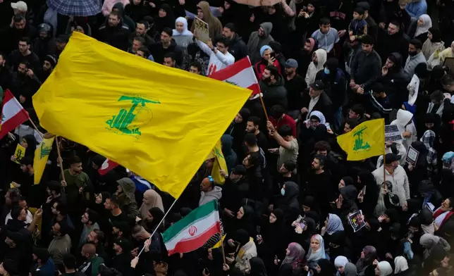 Protesters wave Hezbollah and Iran's flags during a protest against the Lebanese Prime Minister Nawaf Salam, in front the government palace in Beirut, Lebanon, Friday, April 10, 2026. (AP Photo/Hussein Malla)