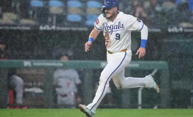 Kansas City Royals' Vinnie Pasquantino runs home to score on a single by Jonathan India during the third inning of a baseball game against the Minnesota Twins, Wednesday, April 1, 2026, in Kansas City, Mo. (AP Photo/Charlie Riedel)