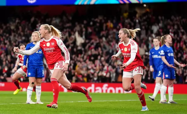 Arsenal's Stina Blackstenius, left, celebrates scoring their side's first goal of the game during the Women's Champions League soccer match between Arsenal and Chelsea in London, Tuesday, March 24, 2026. (John Walton/PA via AP)