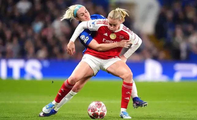 Arsenal's Alessia Russo, left, and Chelsea's Ellie Carpenter battle for the ball during the Women's Champions League quarterfinal second leg soccer match between Chelsea and Arsenal in London, Wednesday, April 1, 2026. (John Walton/PA via AP)