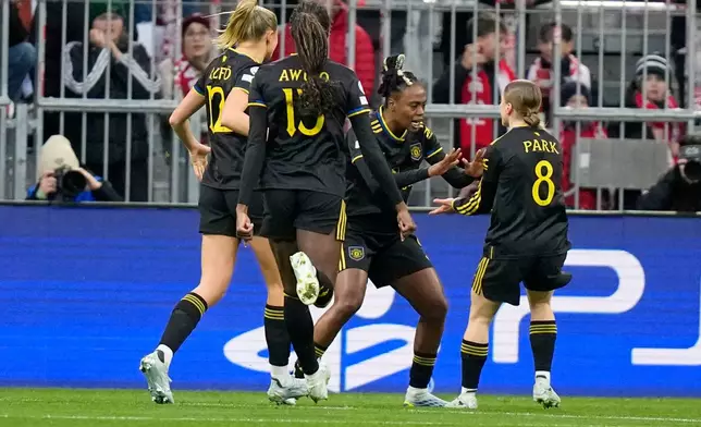 Manchester United's Melvine Malard, second right, celebrates scoring her side's frst goal during the Women's Champions League quarterfinal second leg soccer match between Bayern Munich and Manchester United in Munich, Germany, Wednesday, April 1, 2026. (AP Photo/Matthias Schrader)