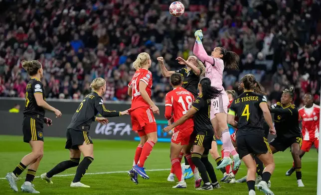 Manchester United's goalkeeper Phallon Tullis-Joyce leaps for the ball during the Women's Champions League quarterfinal second leg soccer match between Bayern Munich and Manchester United in Munich, Germany, Wednesday, April 1, 2026. (AP Photo/Matthias Schrader)