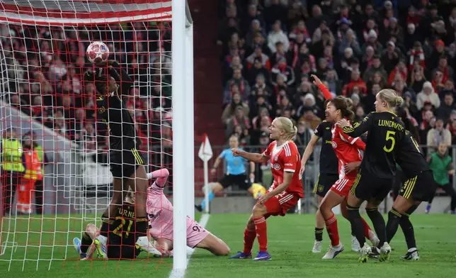 The ball lands behin Manchester United's goalkeeper Phallon Tullis-Joyce bottom left to make it 1-1 during the Women's Champions League quarterfinal second leg soccer match between Bayern Munich and Manchester United in Munich, Germany, Wednesday, April 1, 2026. (Karl-Josef Hildenbrand/dpa via AP)