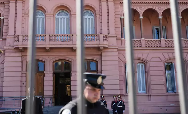 Honor guards stand at attention outside the government house in Buenos Aires, Argentina, Thursday, April 23, 2026. (AP Photo/Rodrigo Abd)