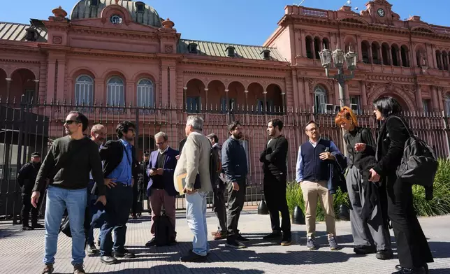 Journalists stand outside of the Casa Rosada government headquarters after President Javier Milei blocked their access, in Buenos Aires, Argentina, Thursday, April 23, 2026. (AP Photo/Rodrigo Abd)