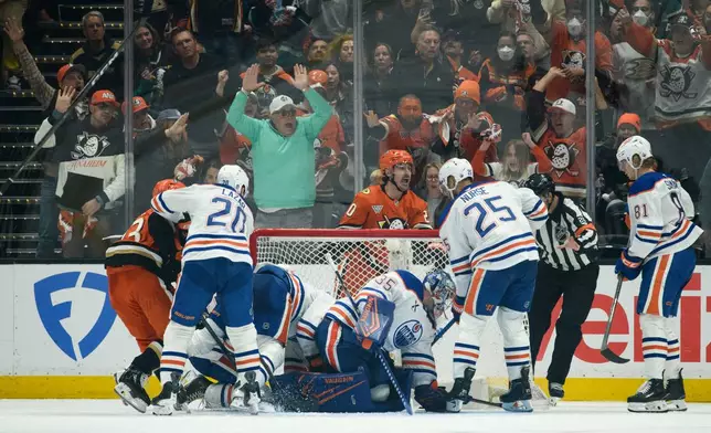Anaheim Ducks left wing Chris Kreider, top center, reacts on the game-winning, overtime goal by center Ryan Poehling, not shown, in Game 4 in the first round of an NHL hockey Stanley Cup playoff series against the Edmonton Oilers, Sunday, April 26, 2026, in Anaheim, Calif. (AP Photo/Kyusung Gong)