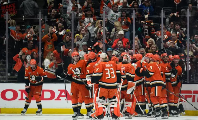 Anaheim Ducks players celebrate the overtime win over the Edmonton Oilers in Game 4 in the first round of an NHL hockey Stanley Cup playoff series Sunday, April 26, 2026, in Anaheim, Calif. (AP Photo/Kyusung Gong)