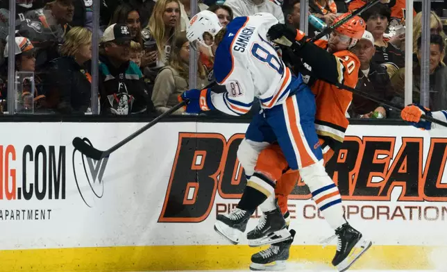 Edmonton Oilers center Josh Samanski, left, hits Anaheim Ducks left wing Chris Kreider during the second period of Game 4 in the first round of an NHL hockey Stanley Cup playoff series Sunday, April 26, 2026, in Anaheim, Calif. (AP Photo/Kyusung Gong)