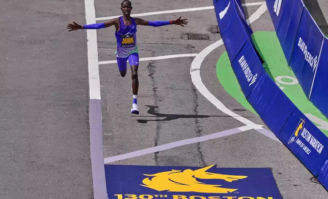 Boston Marathon winner John Korir of Kenya, celebrates while approaching the finish line, Monday, April 20, 2026, in Boston. (AP Photo/Charles Krupa)